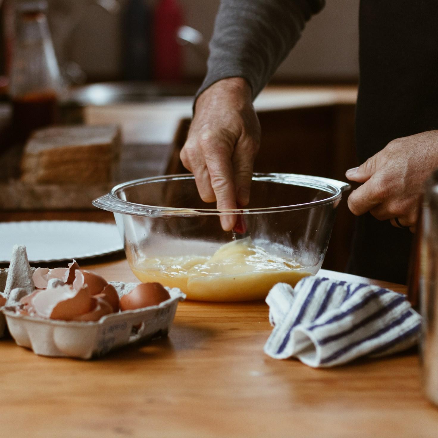 Community members collaborating in a modern kitchen space, sharing recipes and cooking techniques